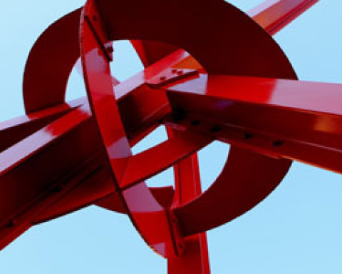 A large red sculpture made out of metal