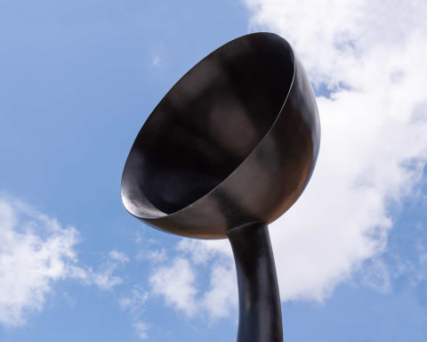 A detail of Simone Leigh's Sentinel IV, which shows the "Bowl Crown" as seen from below looking up with a bright blue sky.