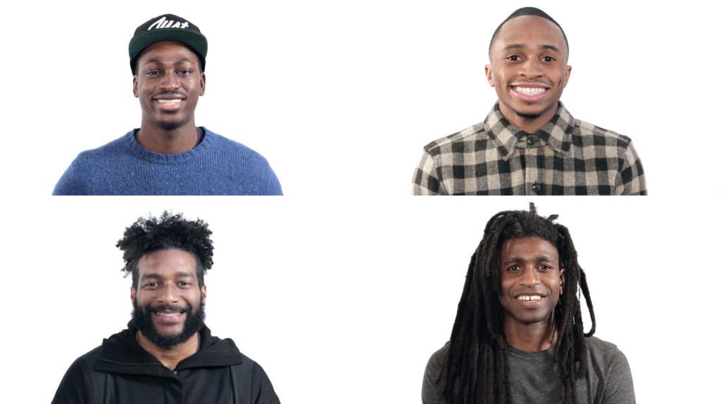 four people smiling against white background