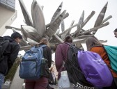 A group of students look up at Nancy Rubin's "Monochrome for Austin"
